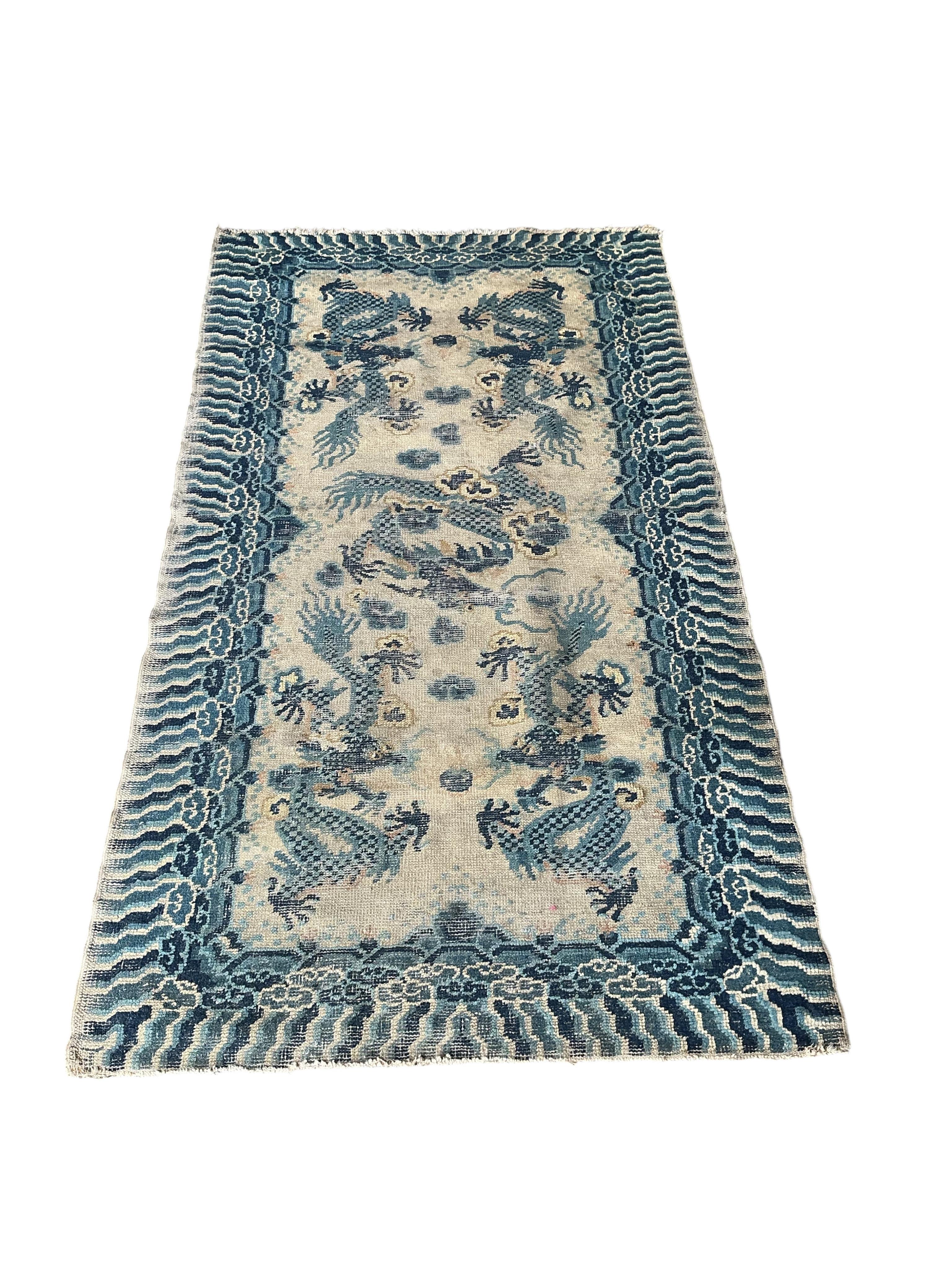A Chinese ivory ground dragon palace rug, Qing Dynasty, 148 x 79cm
